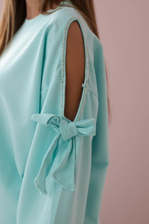 Komplet bluzy z kokardą na rękawach i legginsów miętowy Komplet bluzy z kokardą na rękawach i legginsów miętowy