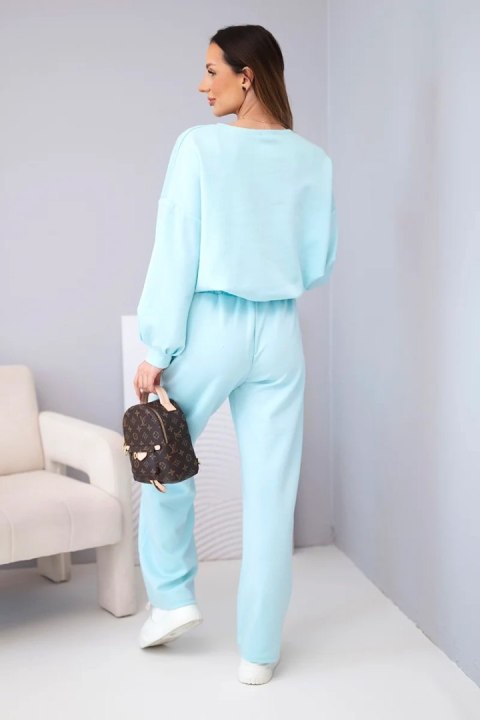 Komplet damski masełko bluza z broszką i spodnie z prostą nogawką błękitny